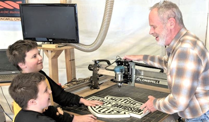 garrett fromme with children using CNC router