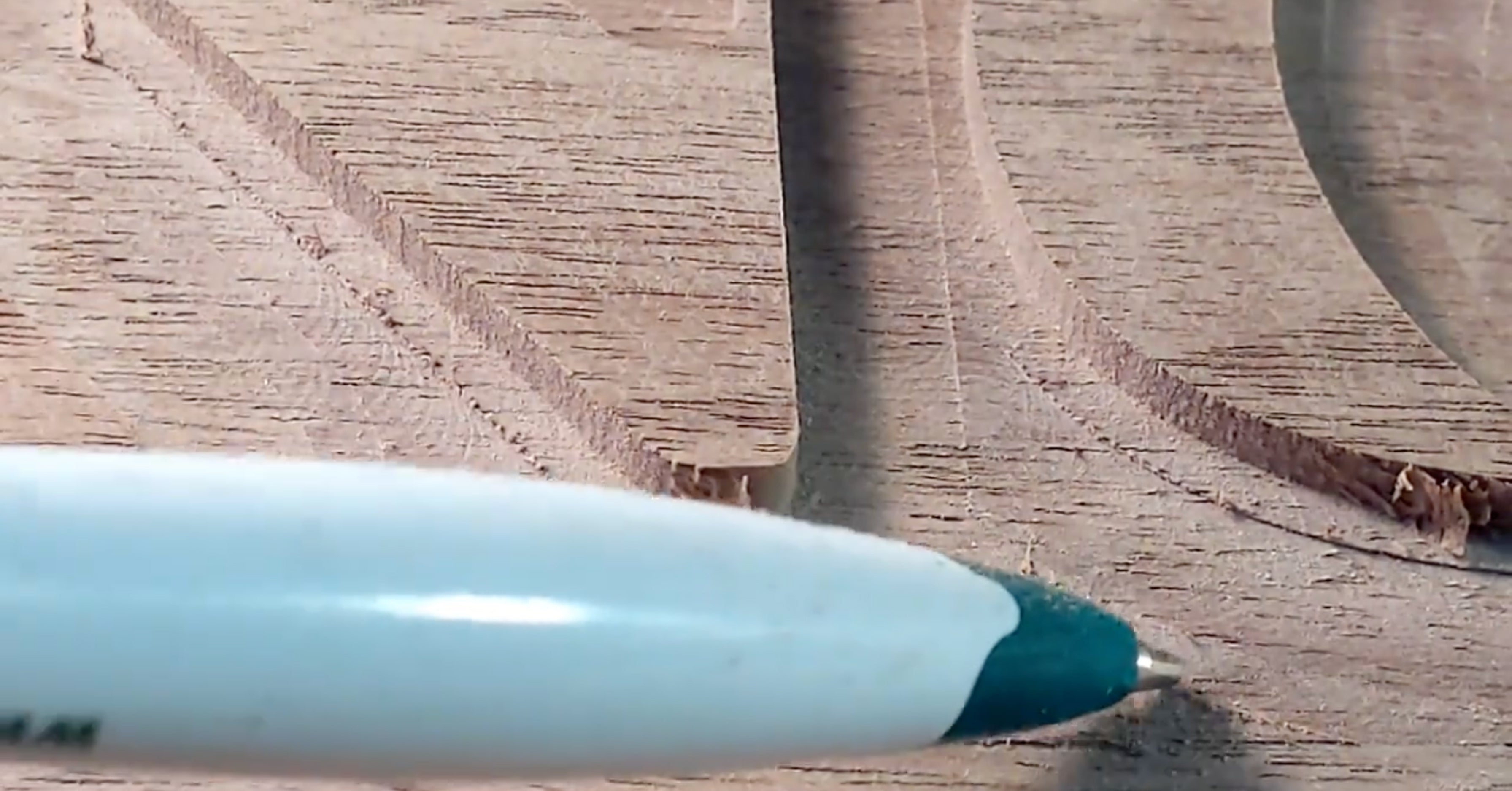 Garrett Fromme points out a rough cut with a pen on a CNC sign created with a CNC Router