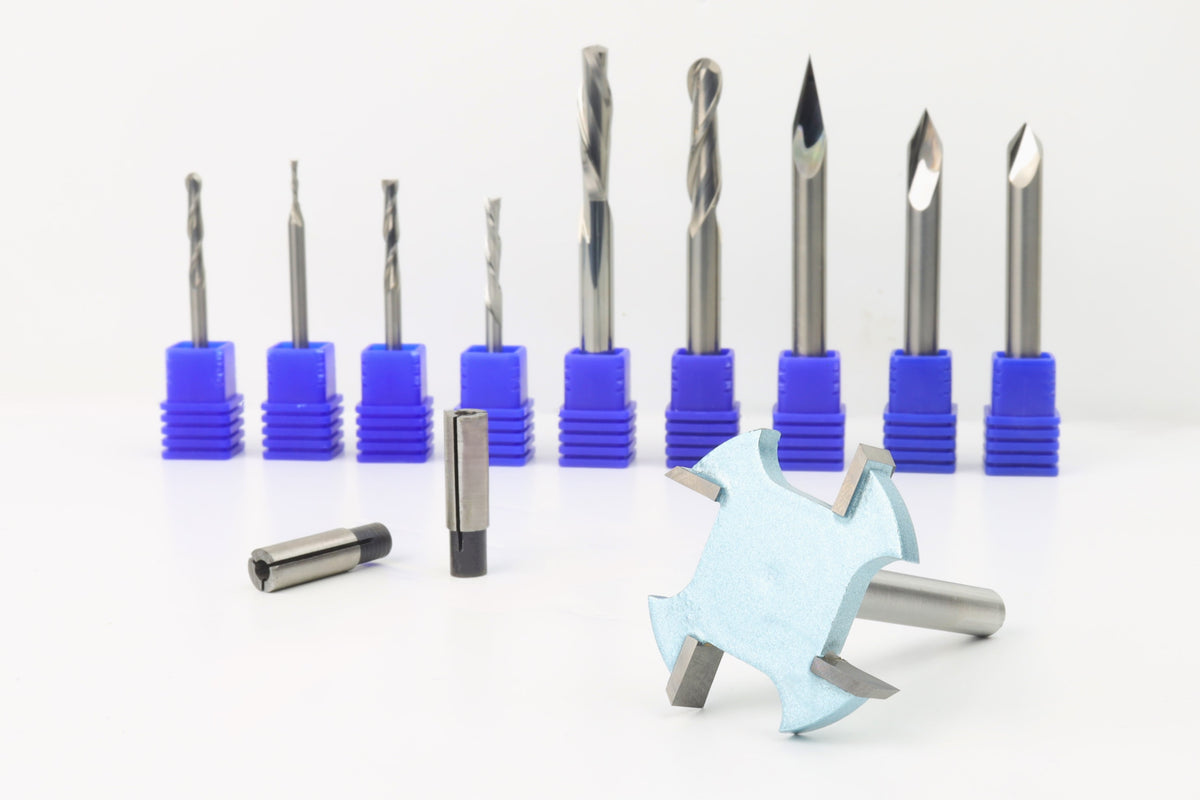 An assortment of CNC router bits displayed in a row, with varying designs for different cutting purposes, mostly in carbide metal with a blue collet.