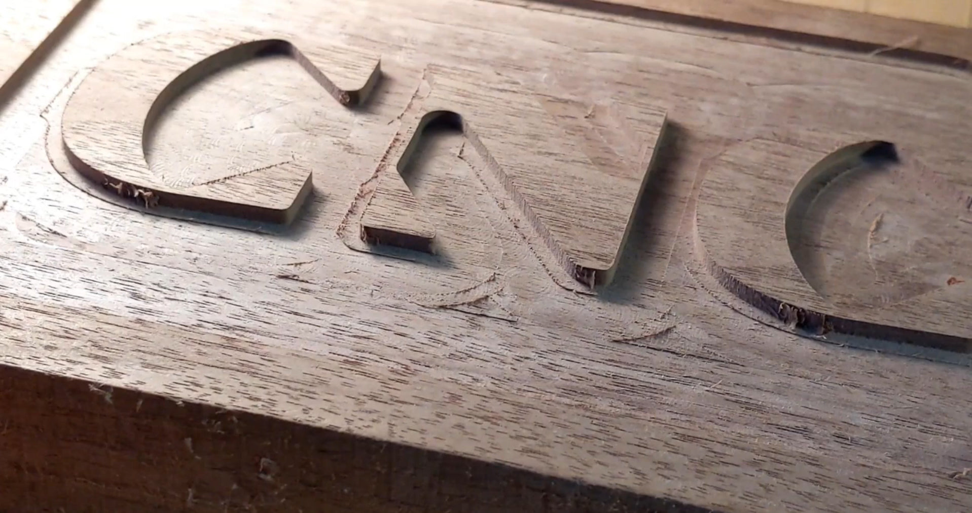 A closeup of a CNC Router project shows uneven lines from aggressive passes
