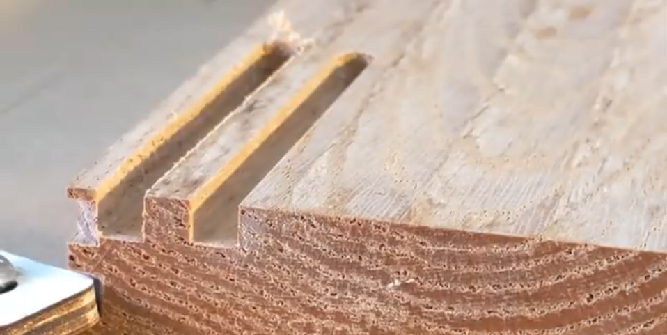 Close up of a piece of woodworking with grooves of uneven depth because of bit choice