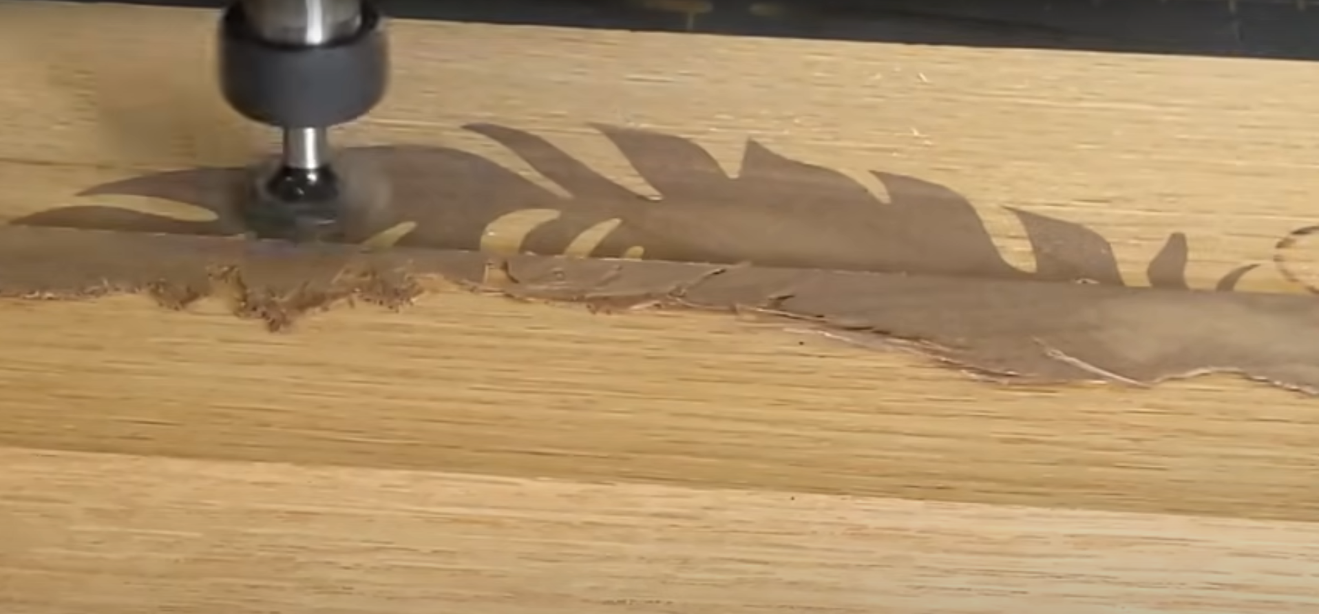 A CNC router shaves a feather inlay flush