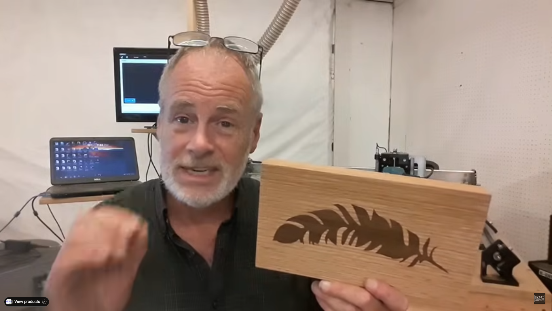 Garrett holds up a finished Feather inlay made with a CNC router